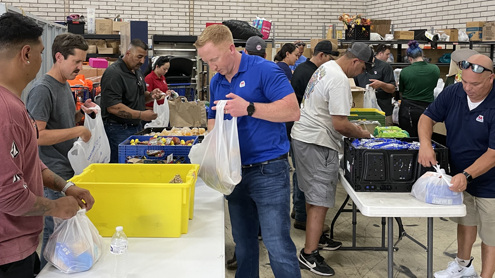 Volunteers packing food bags for homeless individuals and other people in need across the city.