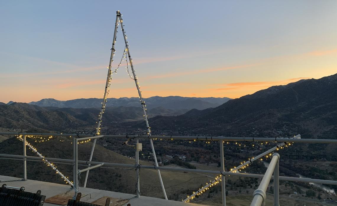 A panoramic view of a valley at sunset. 