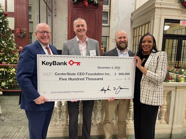 KeyBank presents a $500,000 investment to the CenterState CEO Foundation to support the expansion of business coaching and technical assistance programs for Black, Indigenous and other People of Color (BIPOC), women- and veteran-owned firms in Central New York. Pictured (l to r): Stephen Fournier, KeyBank Central New York market president; Robert Simpson, CenterState CEO president; Andrew Obernesser, CenterState CEO director of community investment; Tamika Otis, KeyBank Central New York corporate responsibility officer. " "