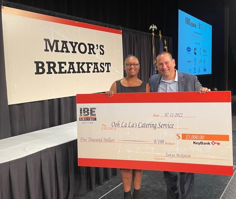 Lakeshia Peterson shown with check from KeyBank for Black Business Training.