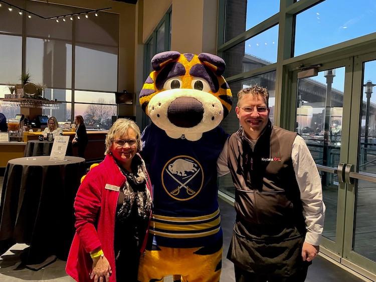 KeyBank volunteers shown with mascot.