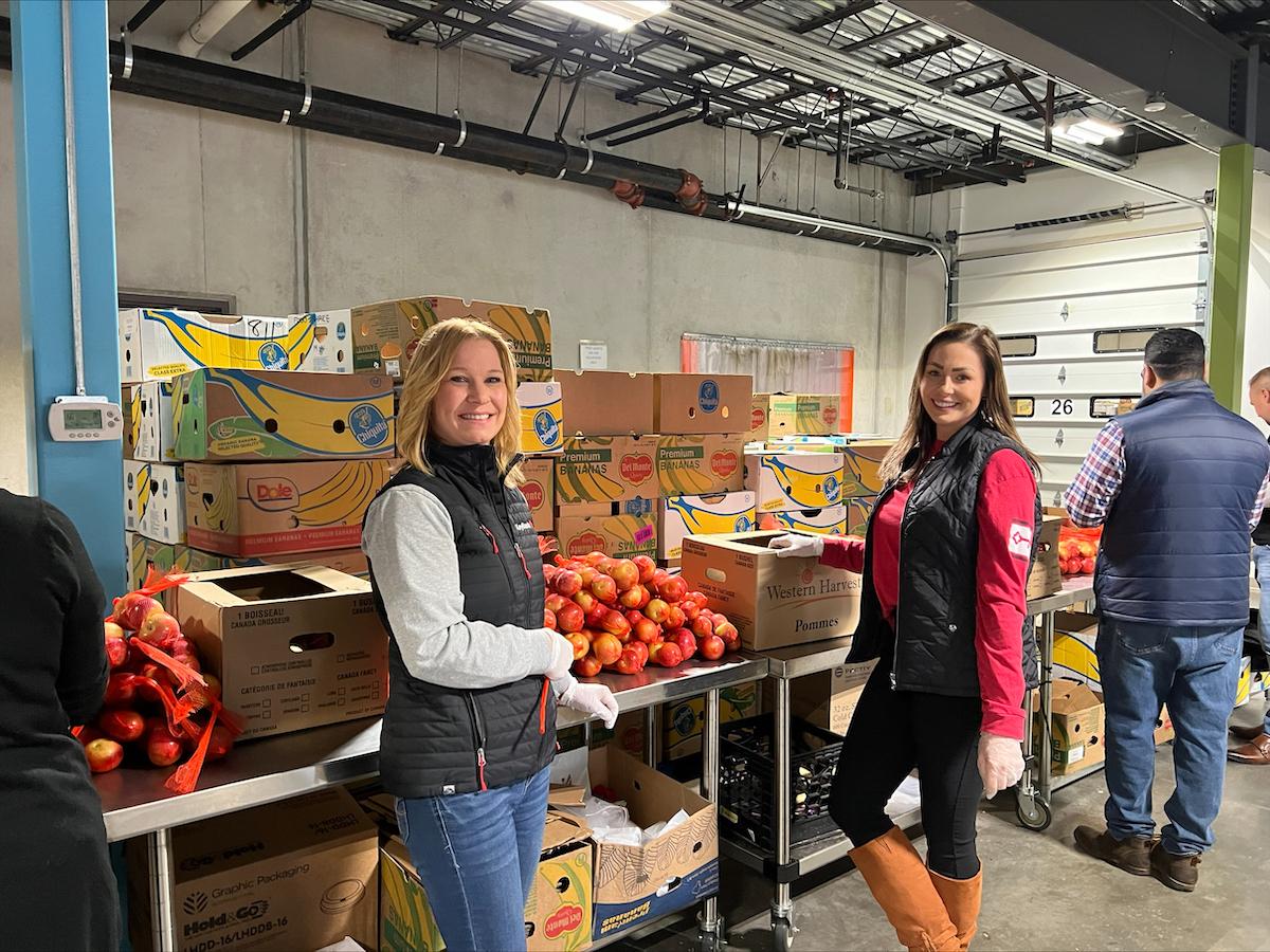 Volunteers at Conn. Food Share warehouse preparing food packages.