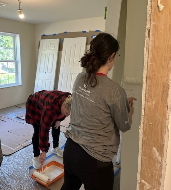 KeyBank volunteers painting walls. 