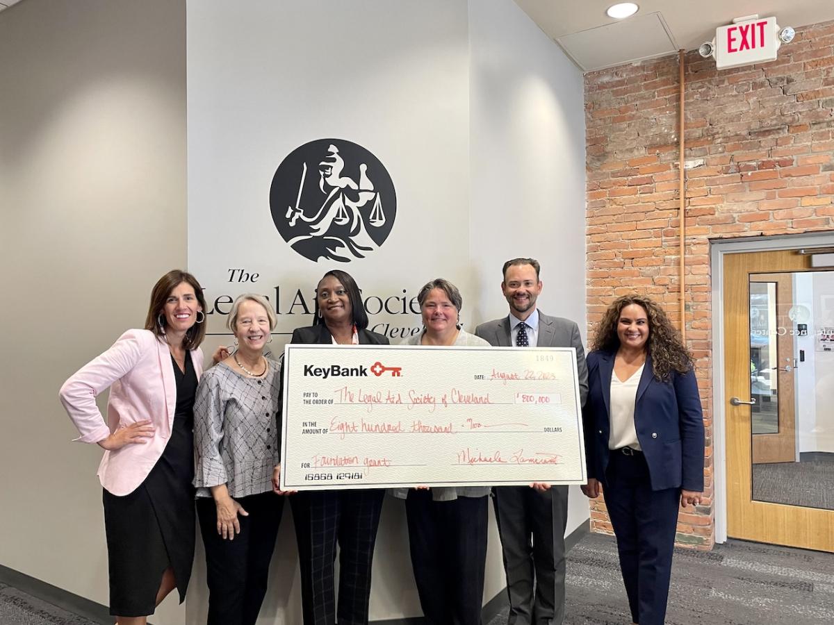Representatives from The Legal Aid Society of Cleveland accept an $800,000 grant check from KeyBank.