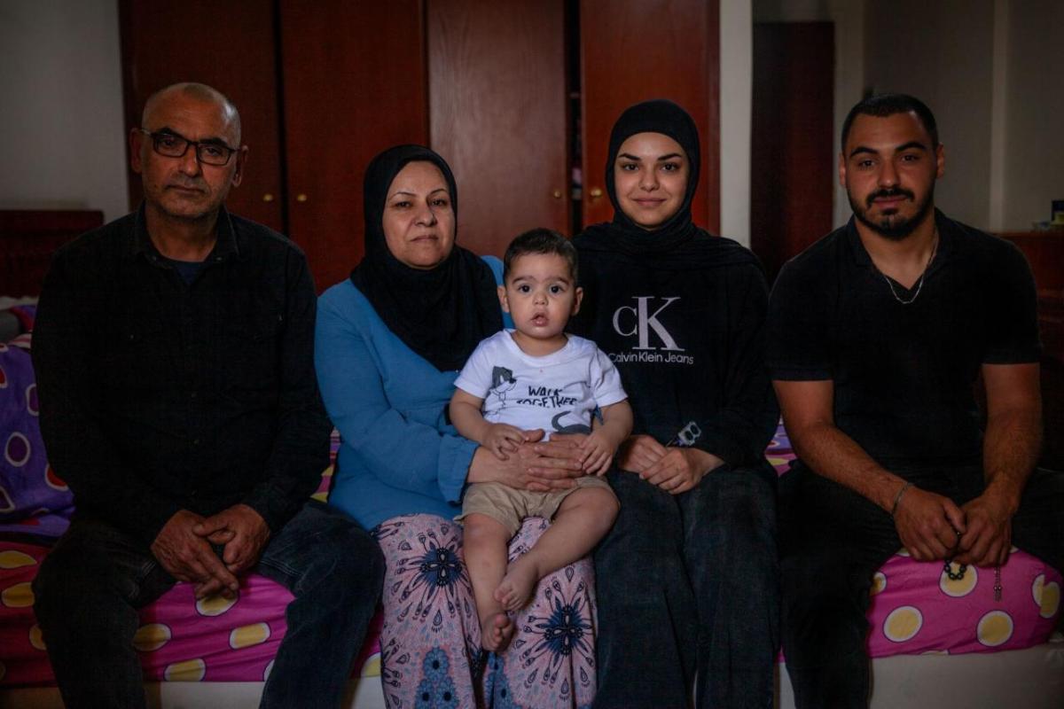 Mahmoud and his family in their room at the Montana Collective Shelter.