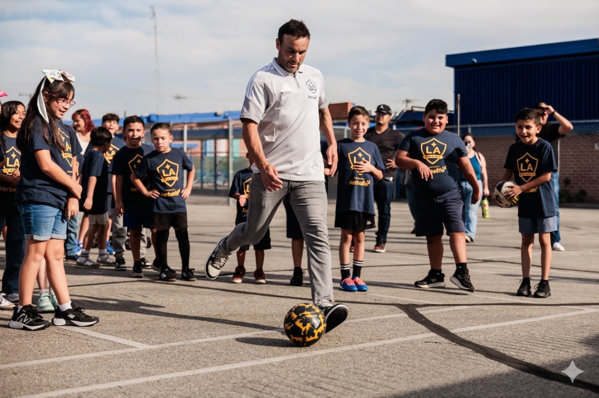 Landon Donovan kicking a soccer ball while surrounded by a group of students.
