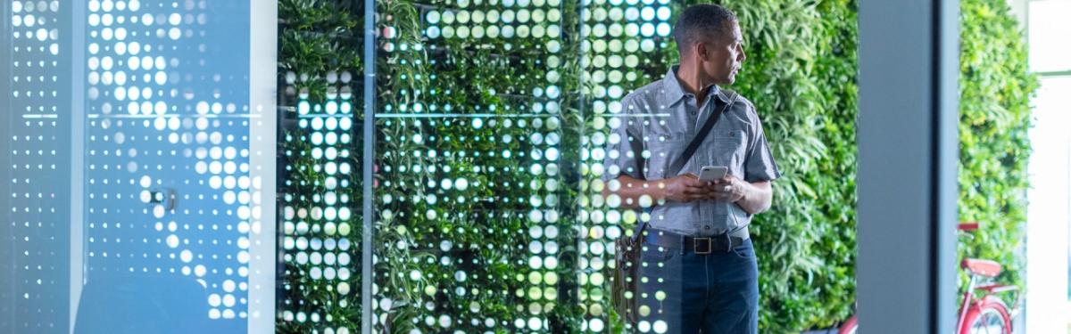 person standing in front of a living wall
