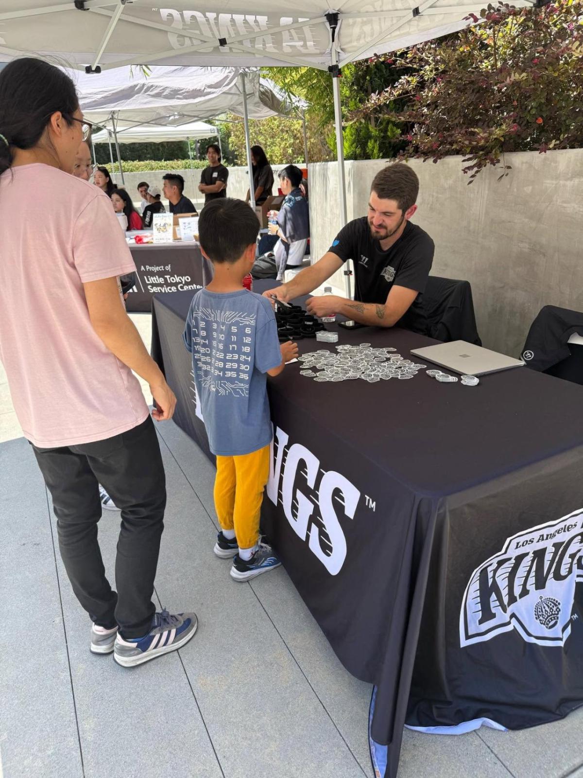 Members from the Little Tokyo Service Center stop by at the LA Kings booth at pLAy Day