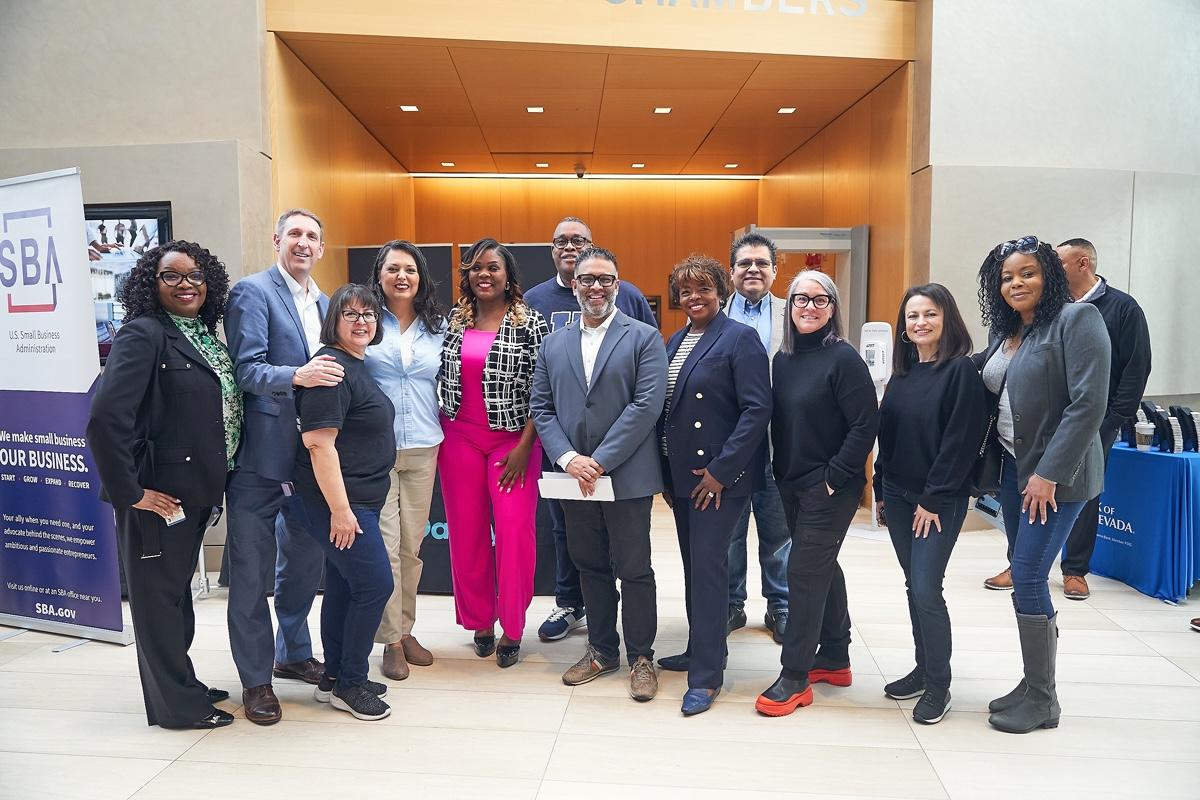 Elected officials along with representatives from GoDaddy, City of Las Vegas, Workforce Connections and Bank of Nevada pose as a group alongside event host Desirae King at the Las Vegas Microbusiness Summit on 2/24/2024. Credit: Kristy Nicholas 