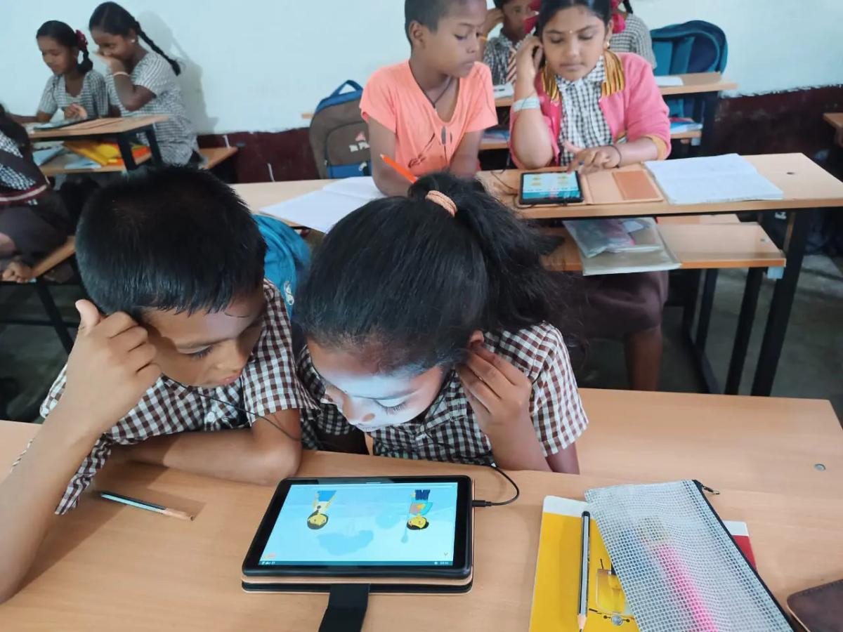 Children using tablets under the Agastya International Foundation’s Lab-on-a-Tab program in Kengeri, Bangalore " "