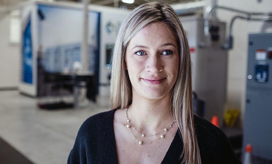 Laurel Meeks, smiling, machines behind her.