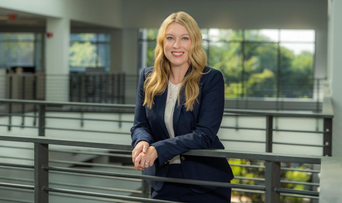 Photo portrait of SEE VP Laura Nennig Tucker standing inside one of SEE's headquarter buildings 