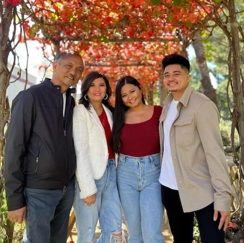 Lea-Angela with her family in an arbor.