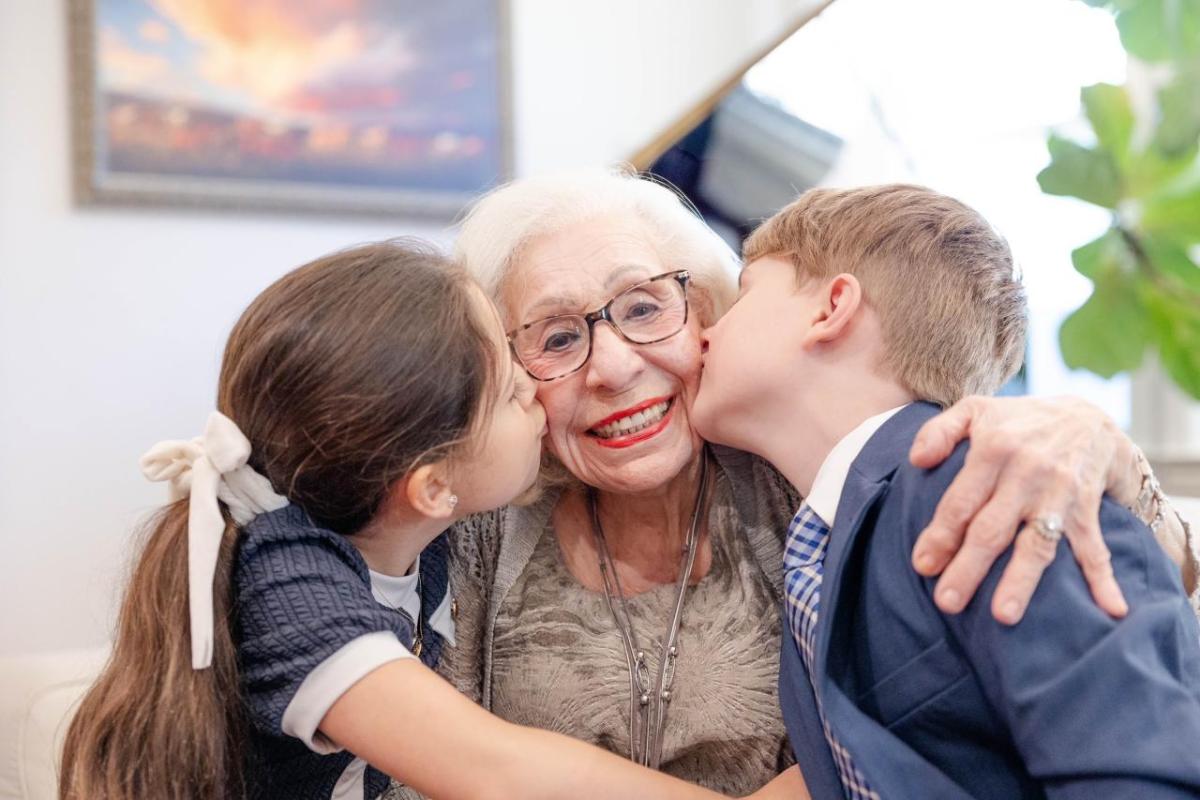 Abuela smiling with two children
