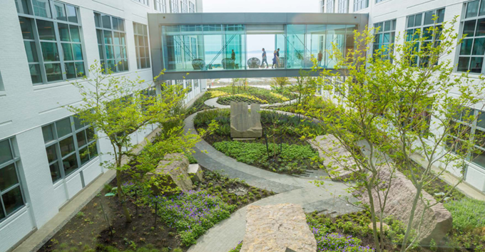 courtyard view of Expedia head quarters, a glass walkway between buildings.