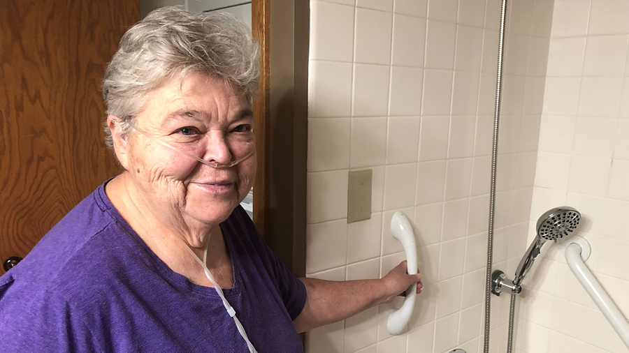 An Age Well at Home client, Linda, with shower upgrades including grab bars and a hand-held shower head.