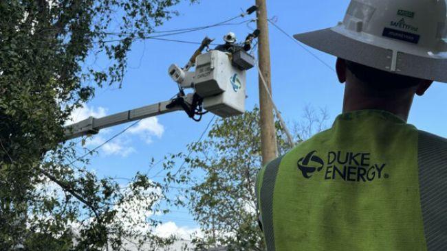 Lineworker in cherry picker fixing the power