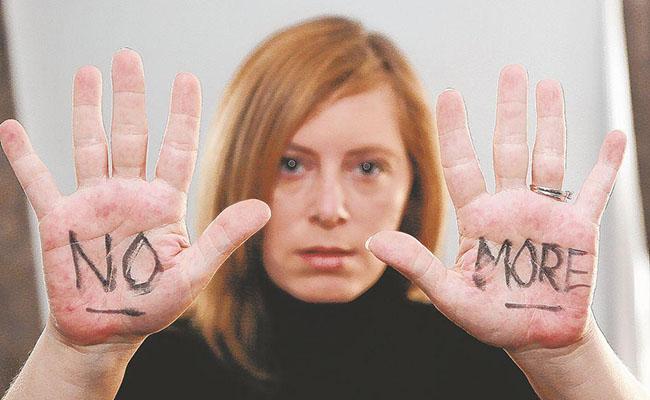 Lisa Colella participating in the "Silent Ranks No More" campaign, representing intimate partner violence at Camp Lejeune.
