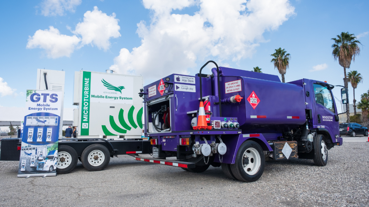 A Booster tanker sits next to a mobile energy solution.