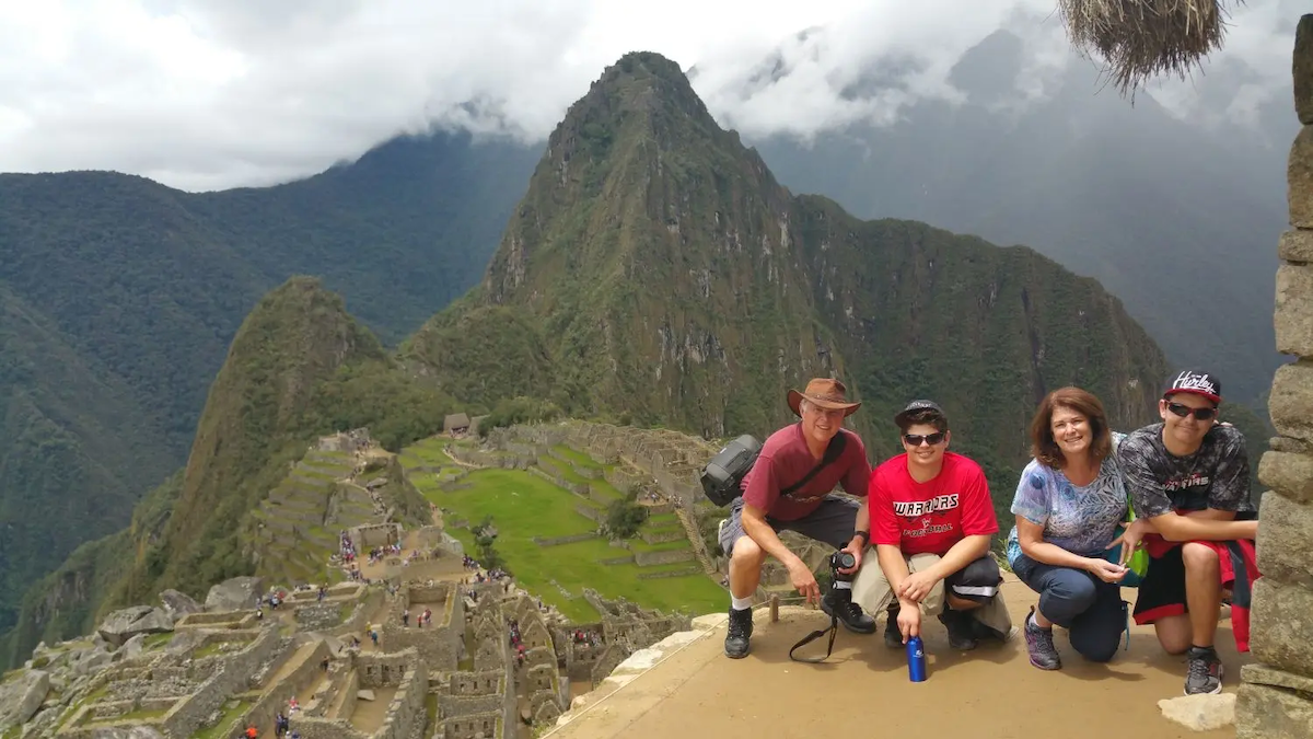 Lori and her family on a mountain overlooking an ancient city.