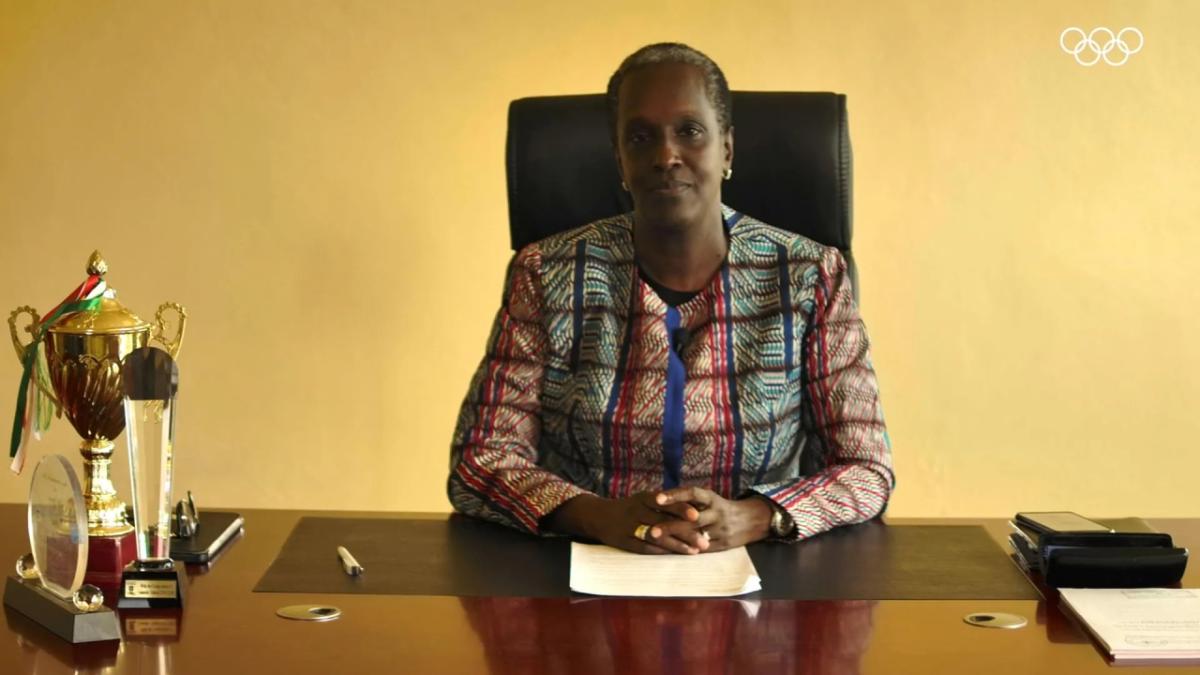 Lydia Nsekera sitting at a desk