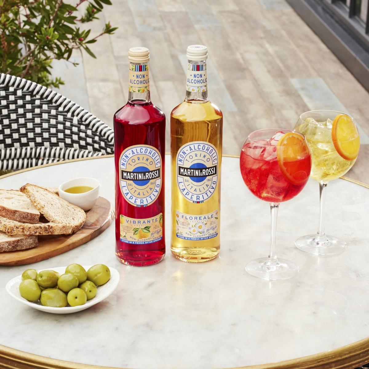 Bottles of MARINTI Non-Alcoholic Aperitivo and Floreale on a table with snacks