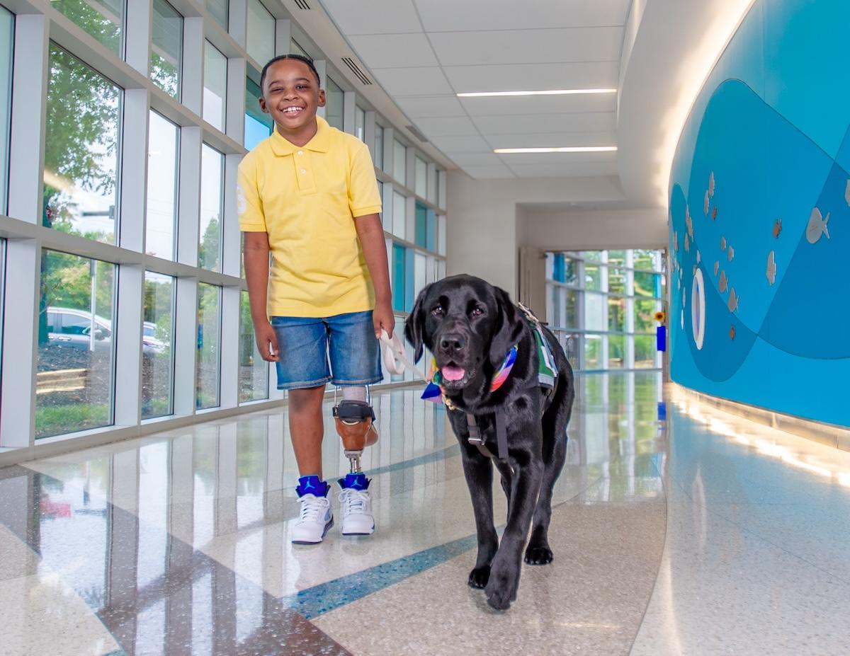 A young cancer patient with his companion dog.