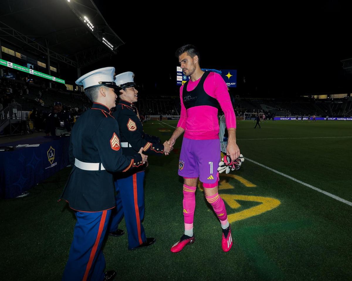 LA Galaxy's Johnathon Bond shakes hands with the Hero Of The Match Sergeant Rechelle Hoppers of the U.S. Marine Corps, who is of the Pride Community.