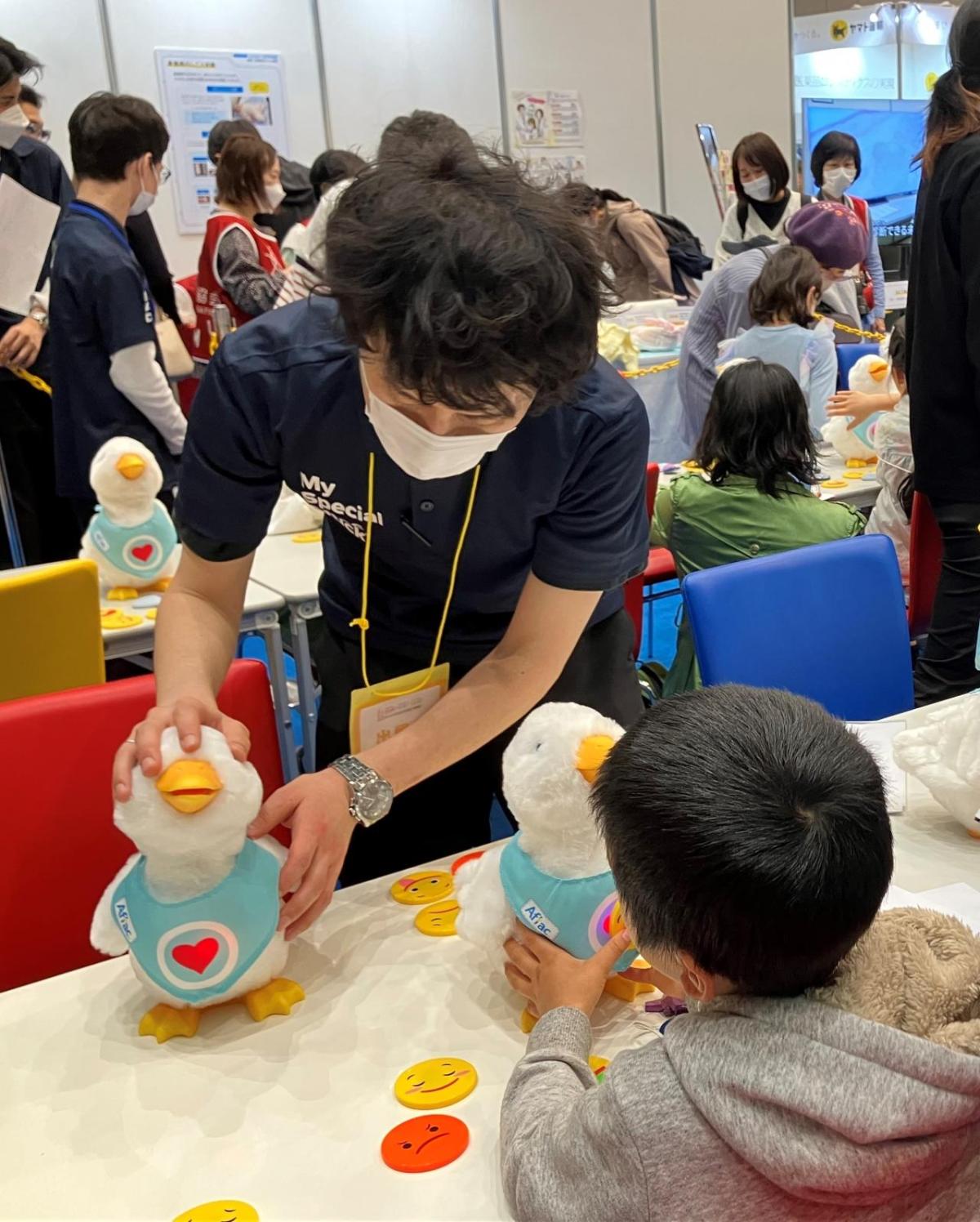 Photo: At the General Meeting of the Japan Medical Association, kids interact and play with social robot My Special Aflac Duck, which provides comfort and joy to kids with cancer and sickle cell disease. At the General Meeting of the Japan Medical Association, kids interact and play with social robot My Special Aflac Duck, which provides comfort and joy to kids with cancer and sickle cell disease.