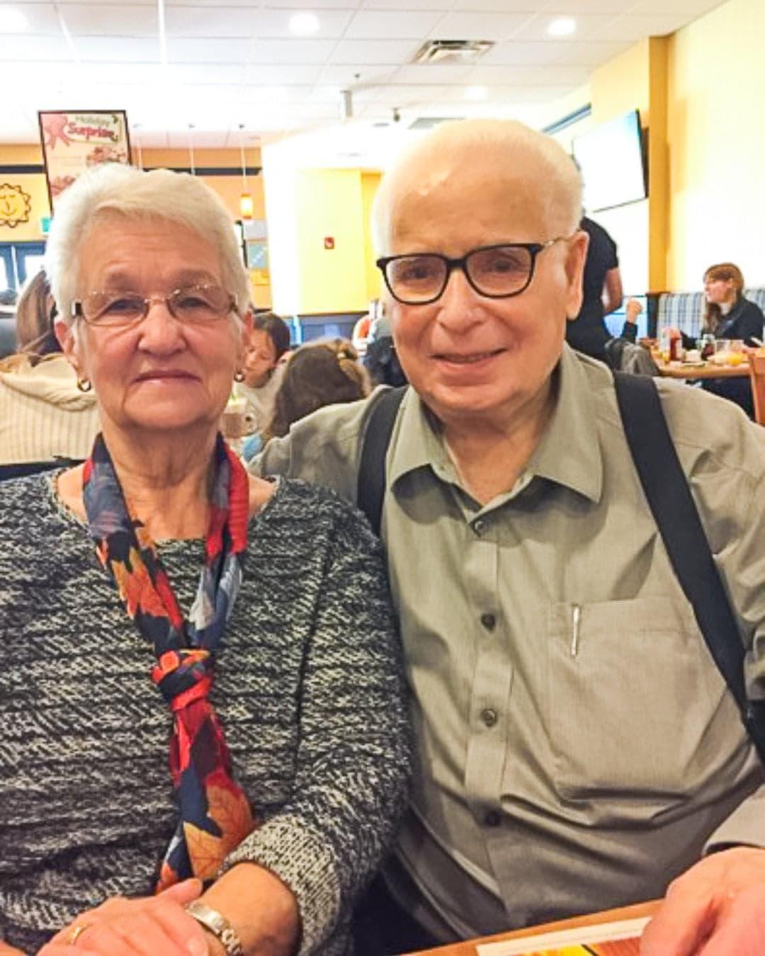 Marie and Germain Routhier seated in a restaurant.