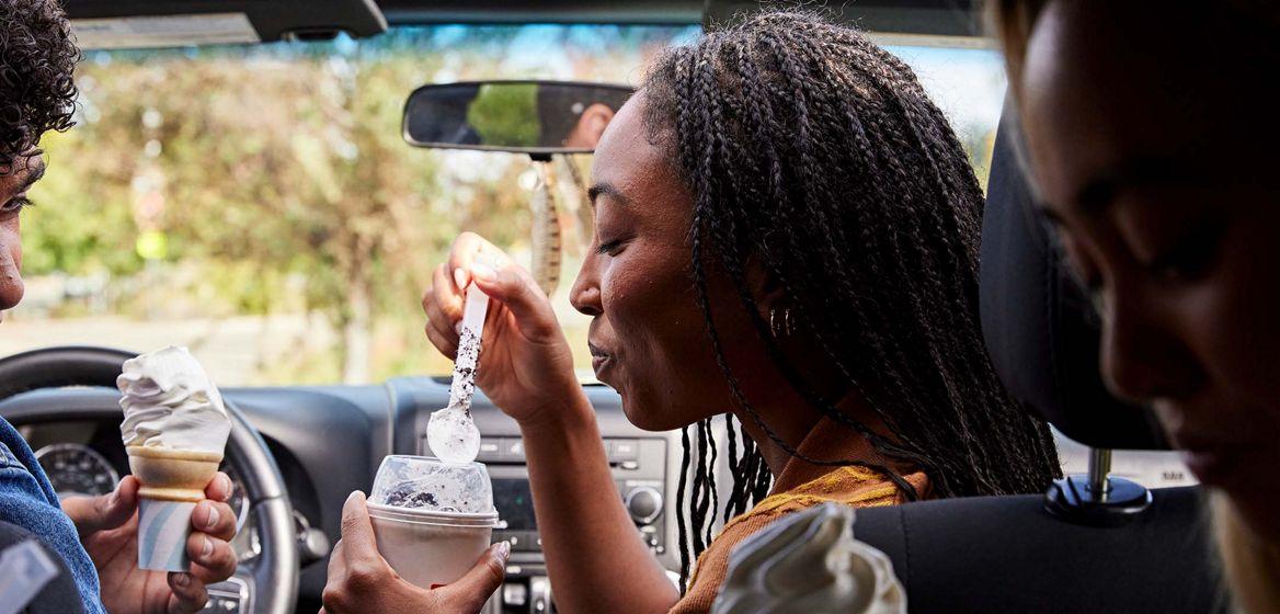 People in car eating ice cream