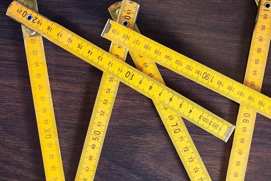 measuring tapes on wooden background