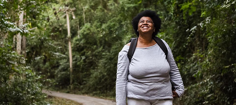 women walking through a wooded trail