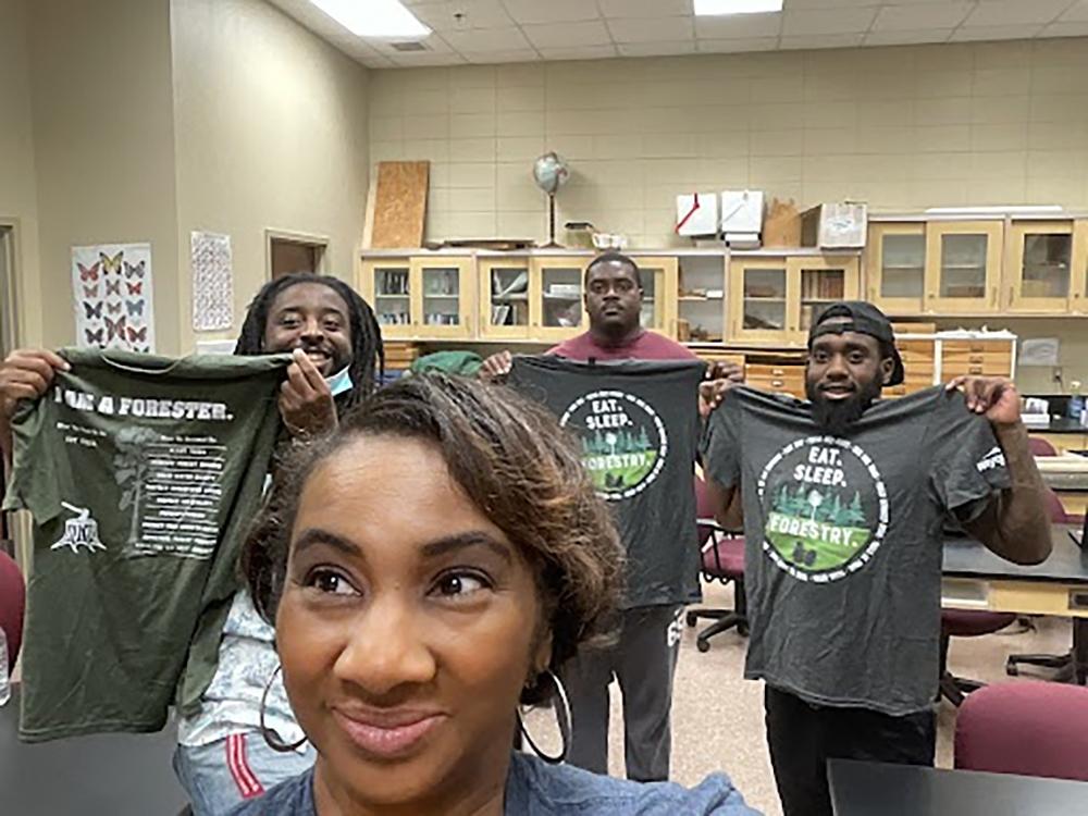 Ebony taking a selfie with some Alabama A&M University students after sharing some Rayonier Tshirts.