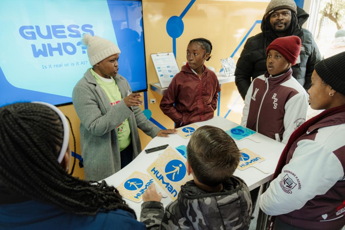 Students with scientists in the Curiosity Cube