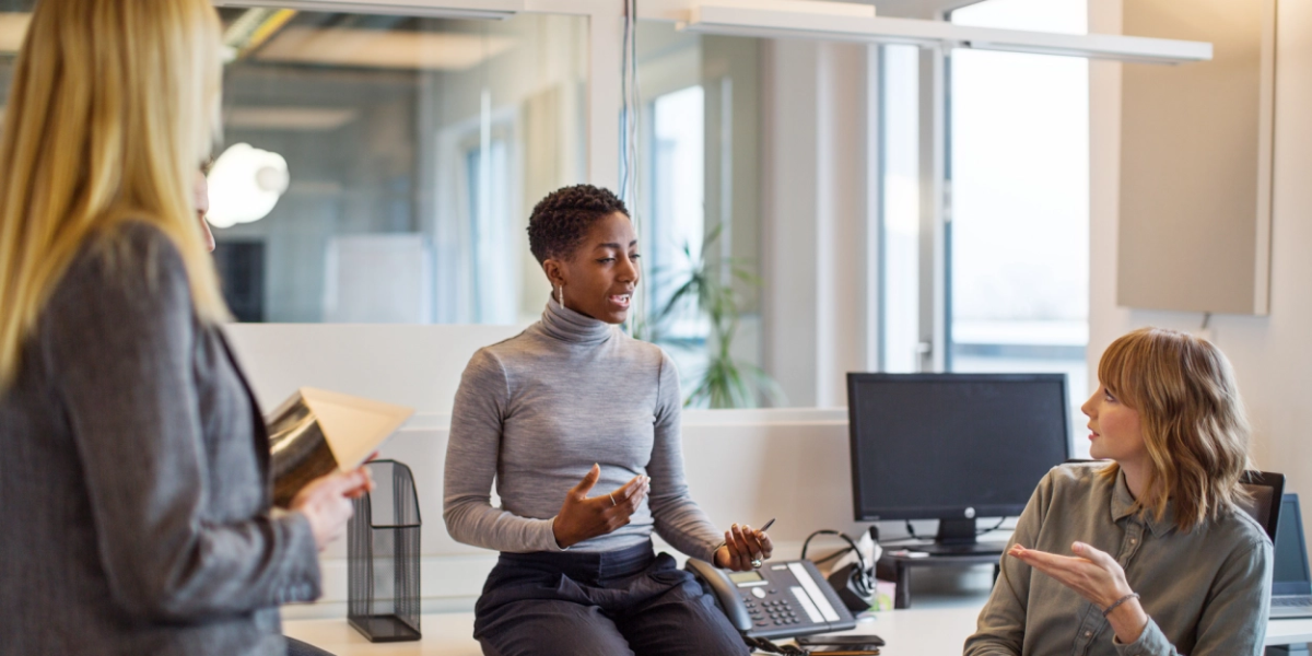 Three women speaking together in an office