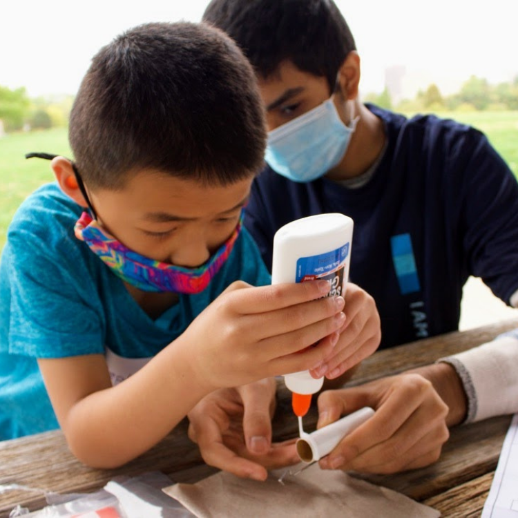 Two kids gluing a project