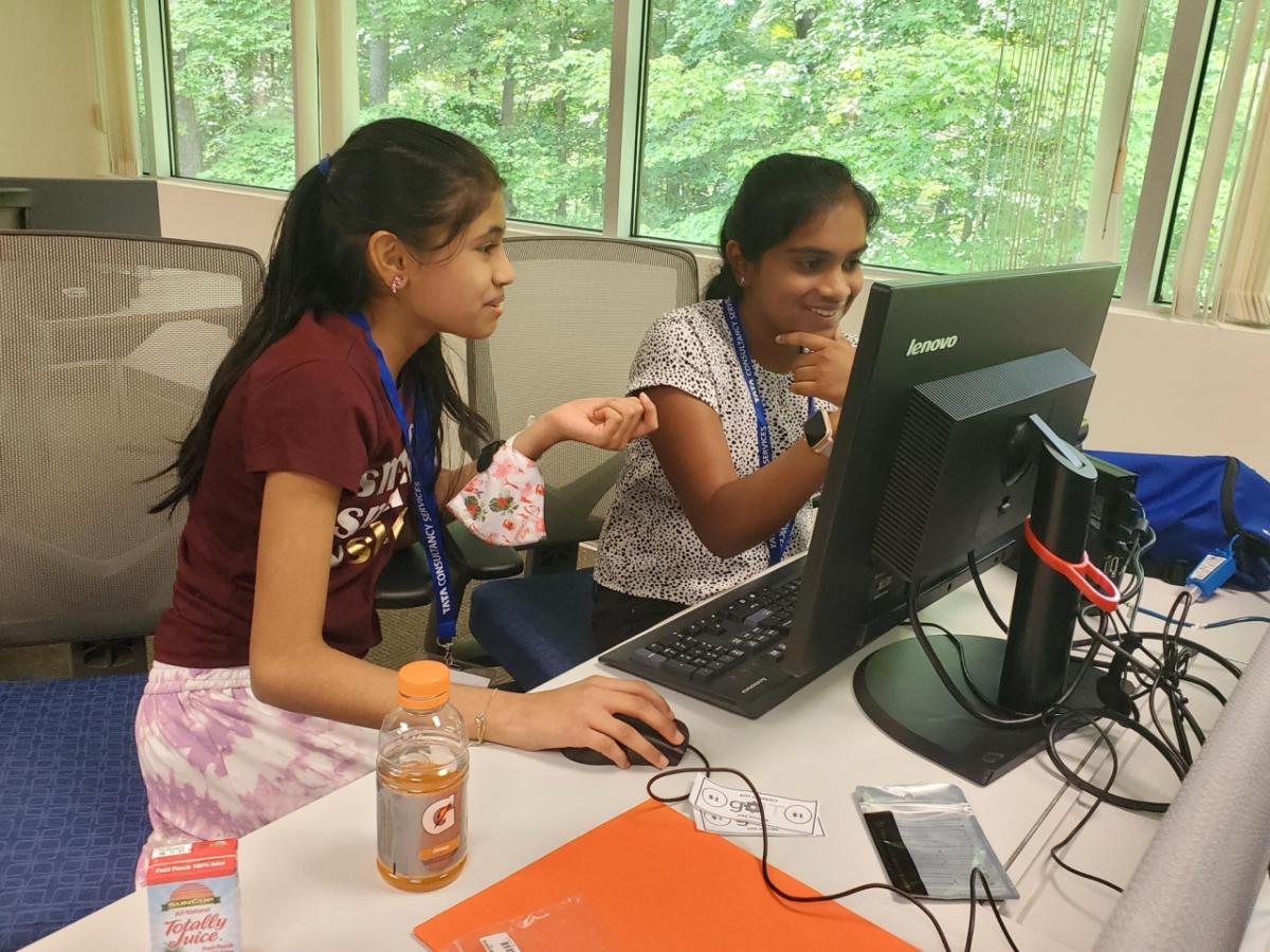 two students on a computer together 