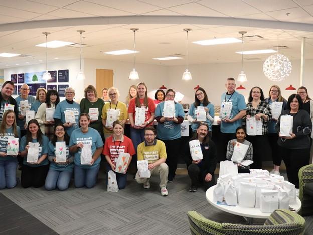 Group of people standing with snack bags