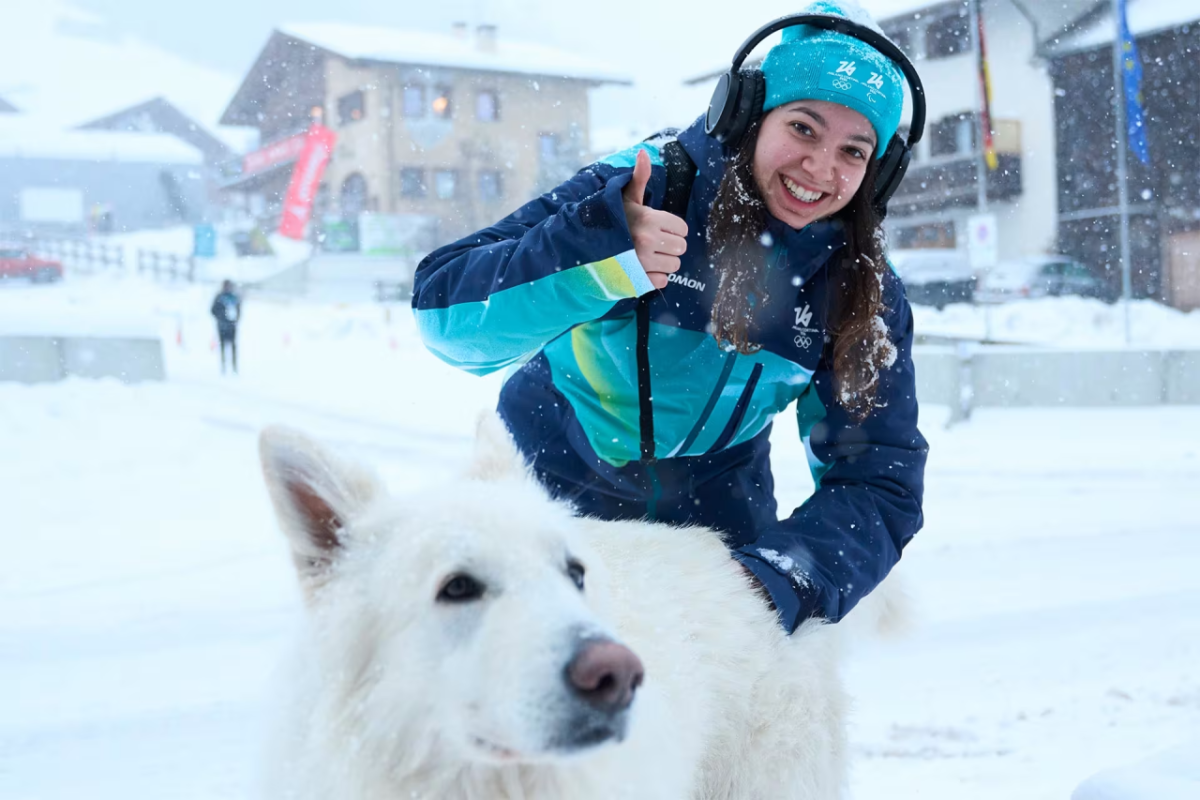 Athlete with large white dog in Olympic Village