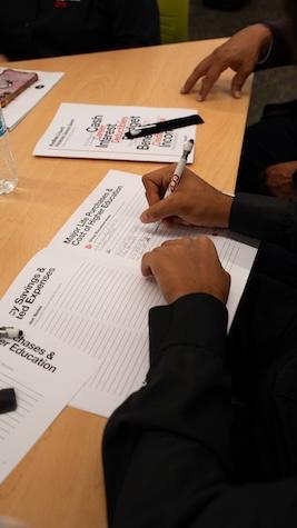 Student writing in a notebook.