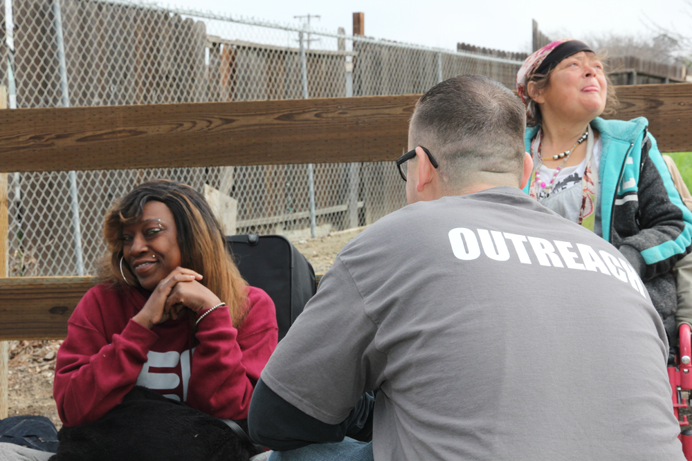 Volunteer speaking with woman in chair