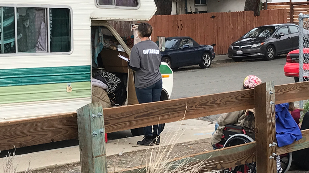 Volunteer standing at door of motorhome