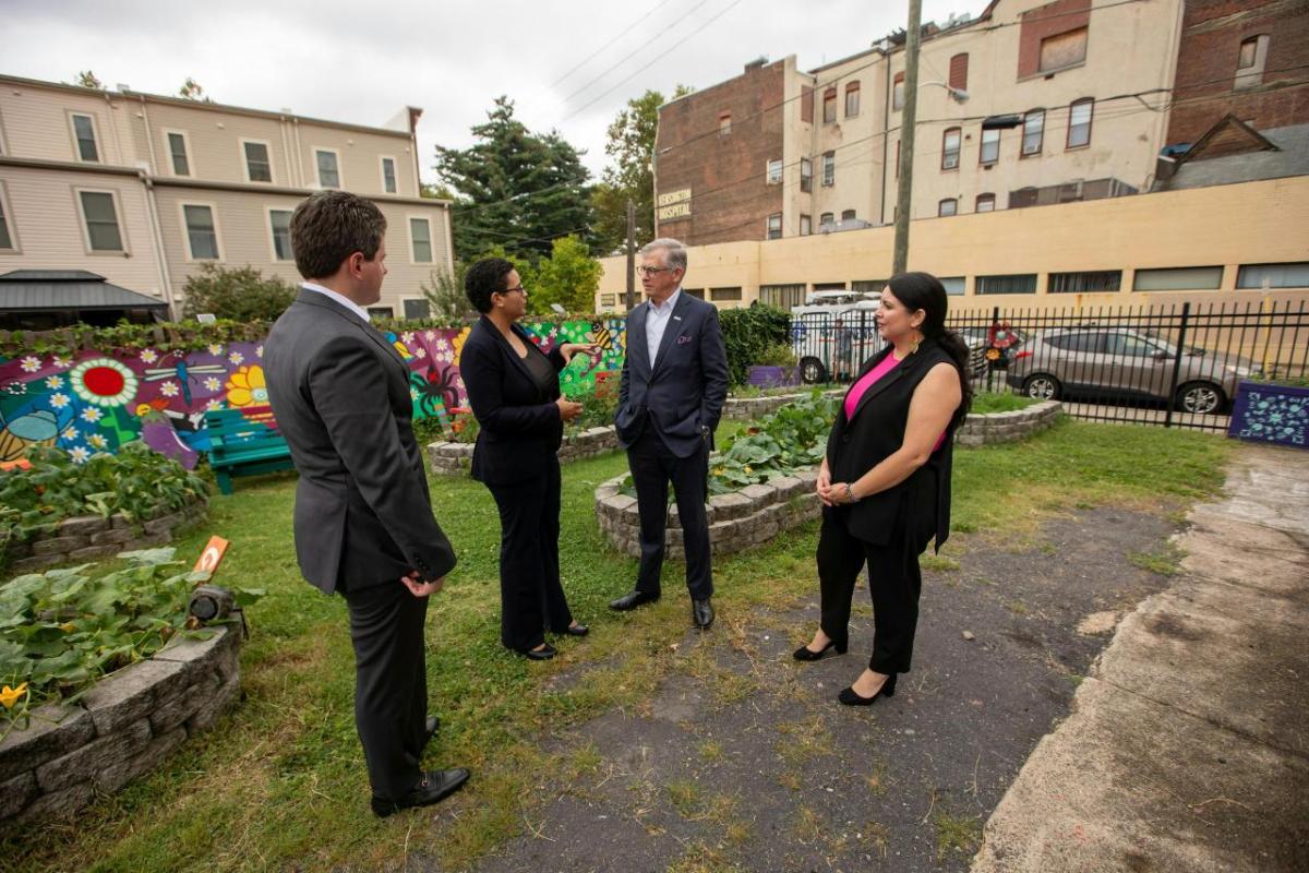 Leaders from Truist and National Association for Latino Community Asset Builders (NALCAB) tour the Norris Square Community Alliance Garden after announcing Truist Foundation donated $1.2 million to NALCAB to help advance economic mobility in communities in Philadelphia and beyond on Friday, Aug. 25, 2023. (Pictured L-R: Jeremy Ben-Zev, Philadelphia market president, Truist; Michelle Carrera, executive director, Norris Square Community Alliance; Bill Rogers, chairman and CEO, Truist Financial; Alejandra Amaroli, director of resource development, National Association for Latino Community Asset Builders.) Leaders stand together