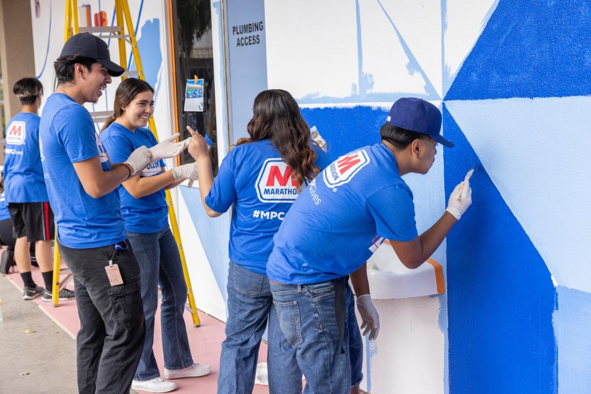 group of students painting building