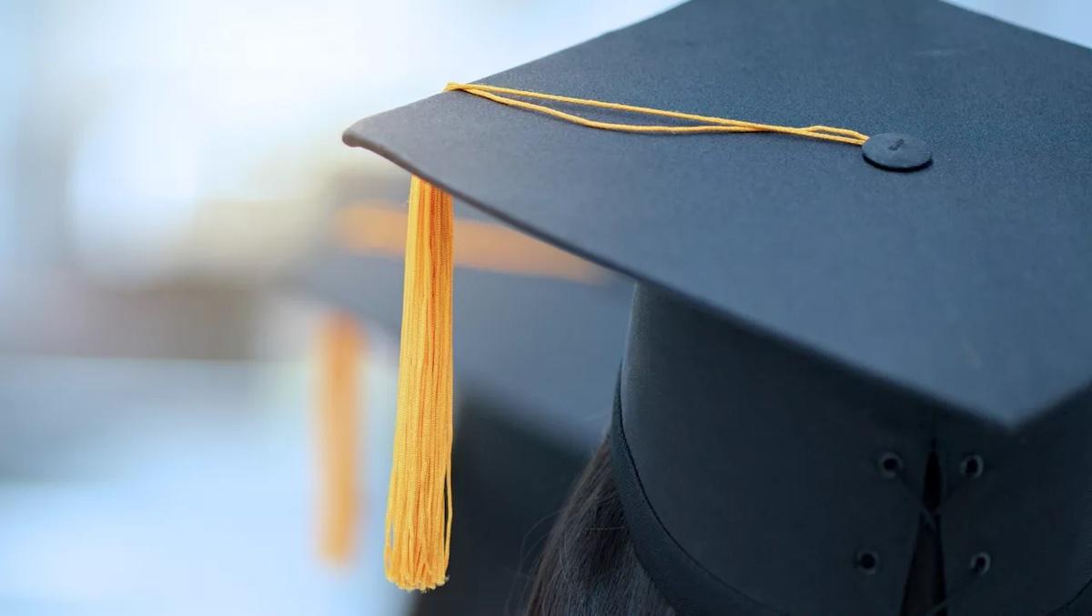 Graduates mitre shown with gold tassel.