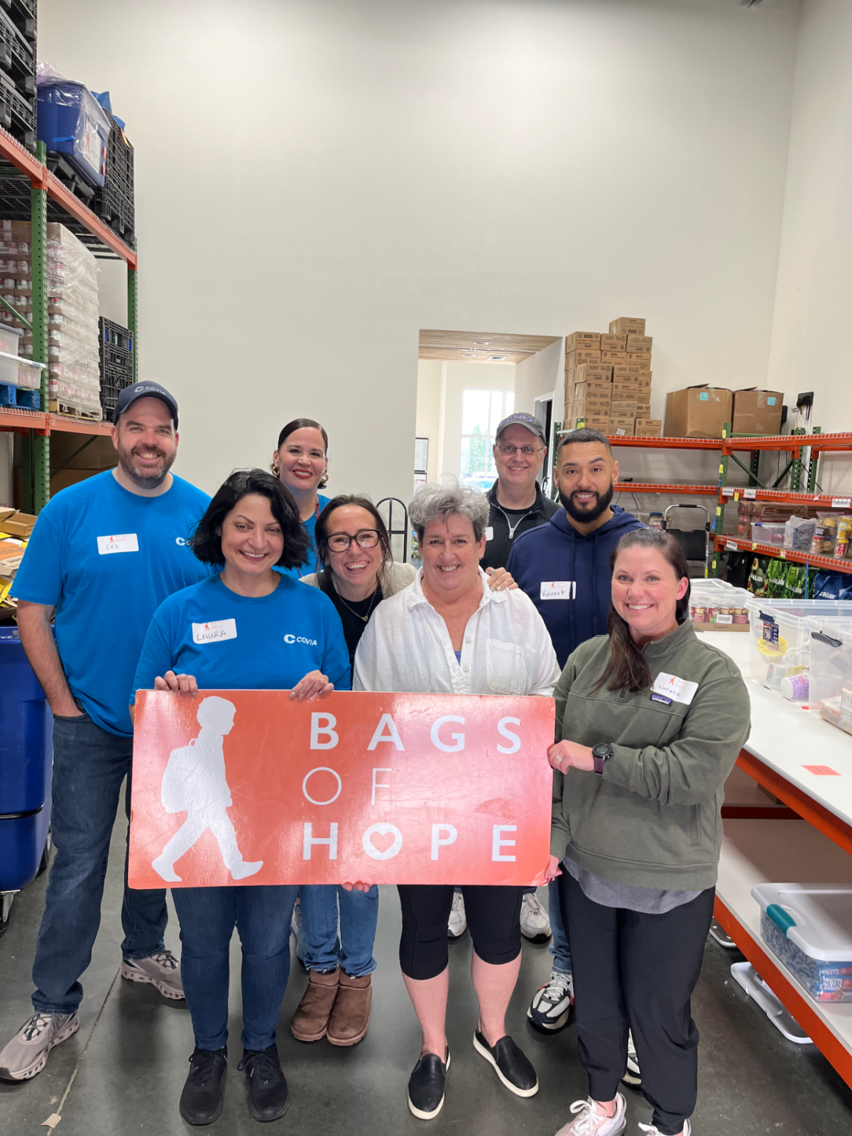 Group holding Bags of Hope sign