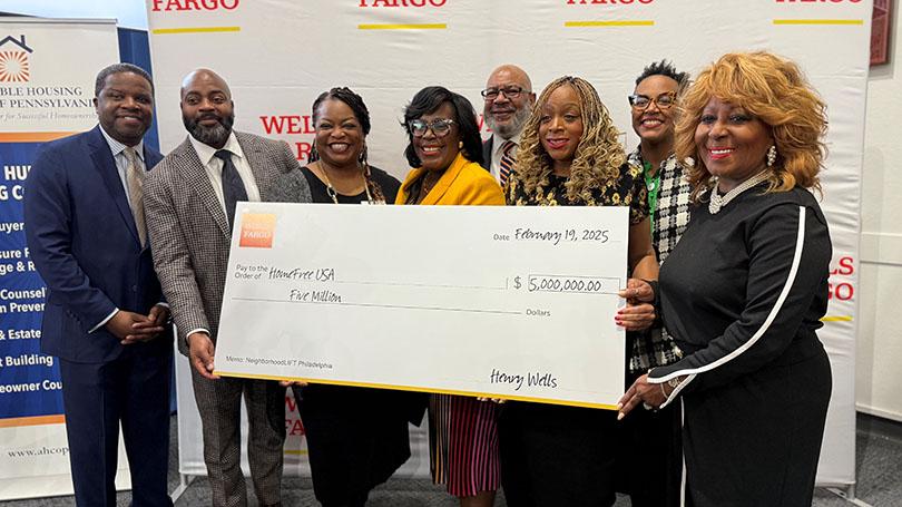 From right: Stephen Briggs, Wells Fargo Philanthropy and Community Impact; Wells Fargo Head of Housing Access and Affordability Philanthropy Stacy Spann; Wells Fargo Head of Philanthropy and Community Impact Darlene Goins; Philadelphia Mayor Cherelle Parker; David Thomas, City of Philadelphia; Philadelphia Councilmember Jamie Gauthier; Angela Brooks, City of Philadelphia; and HomeFree-USA CEO Marcia Griffin during a homebuyer event on February 19, 2025 at the Enterprise Center. Group of people standing in front of a conference room holding a $5 million check.