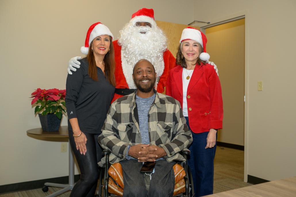 Entergy customer posing for picture with Santa and Entergy officials