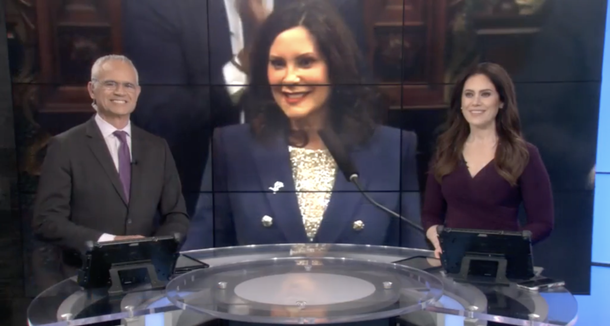 Image courtesy of ABC57. Watch the video here: https://www.abc57.com/news/governor-whitmer-to-tour-housing-development-in-benton-harbor-thursday Two news hosts sat at as desk with a screen behind them